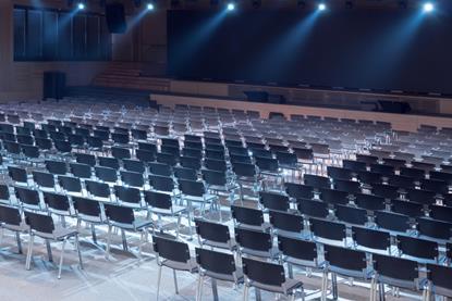 Rows of empty seats in a conference hall
