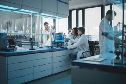 Wide shot of a group of researchers in the lab