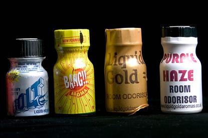 A photo of four small poppers bottles. Their colourful plastic wrappers advertise them as room odourisers or aroma with brand names such as Liquid Gold, Bolt and Purple Haze