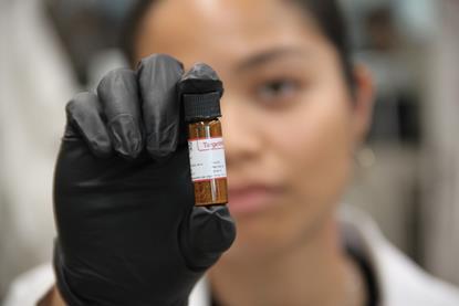 Denise Catacutan with a glass vial