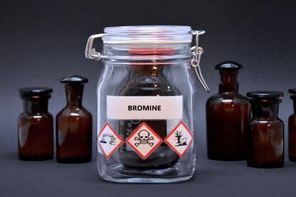 A bottle of bromine sealed in an additional jar with hazard warnings on the label