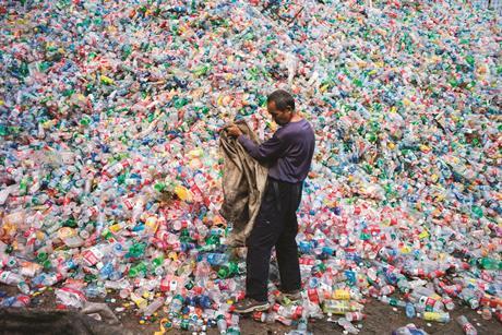 Collecting plastics from polluted river in Manila, Philippines