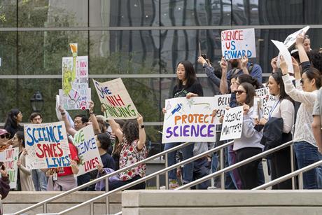 A group of people at a protest to promote and protect science in the USA