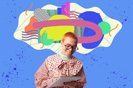 A person with short orange hair in a red-and-white patterned blouse makes notes on a large notepad; above them, their thoughts are represented by coloured shapes