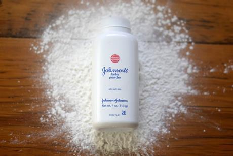 A tub of Johnson's baby powder lying in some white powder
