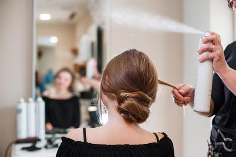 Hairstyling process using hairspray in a beauty salon