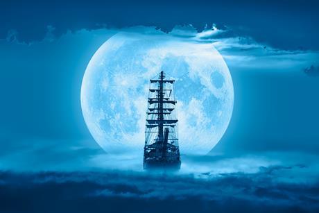 Sailing old ship in a storm sea with full moon stormy clouds in the background