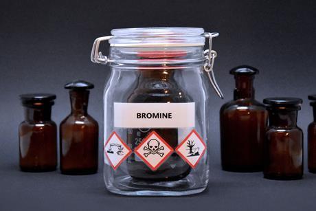 A bottle of bromine sealed in an additional jar with hazard warnings on the label