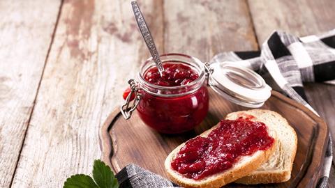 Jam jar and toast on a wooden board