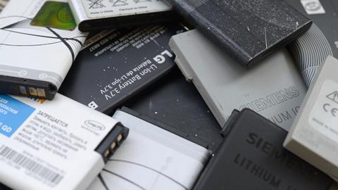 An image showing a bunch of old used mobile phone batteries
