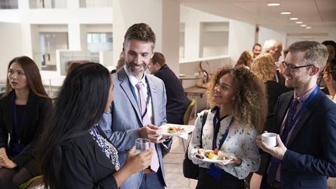 A photograph of people networking at an event