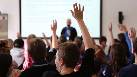 An image showing students Raising Hands During Seminar