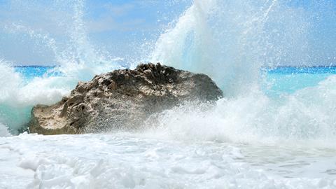 Waves splashing on a rock producing spray