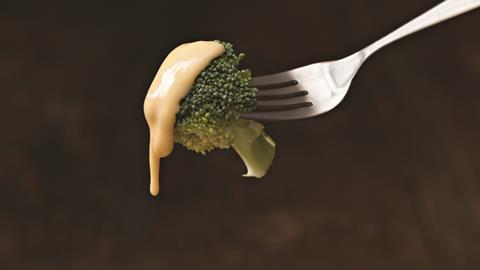 Broccoli dipped in cheese sauce 