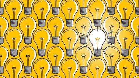 Lit light bulb in a sea of unlit light bulbs