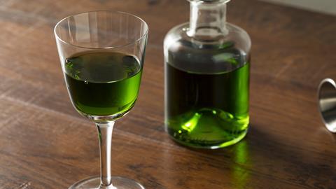 Glass and bottle of absinthe