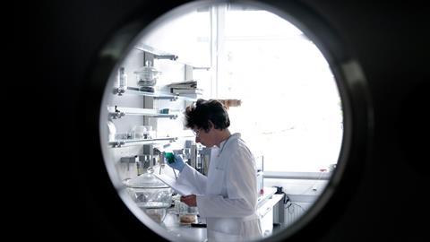 An image showing a researcher framed by a round window