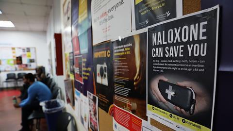 A sign for Naloxone in a room where students learn about opioid overdose prevention