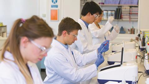 Chemistry students using UV spectrometers