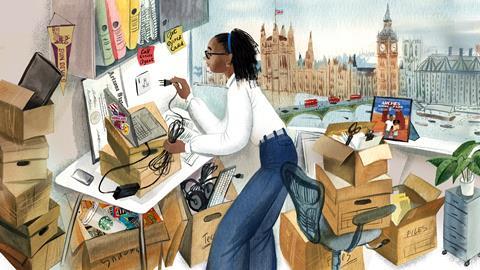 Woman unpacking her office with a view of the London skyline on the window