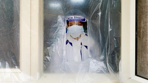 An image showing a health worker wearing personal protective equipment