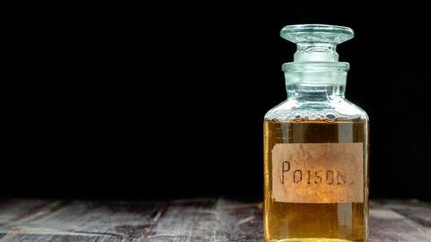A bottle of poison on a table 