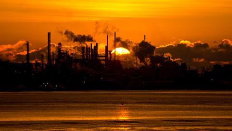 Sun rising over refinery