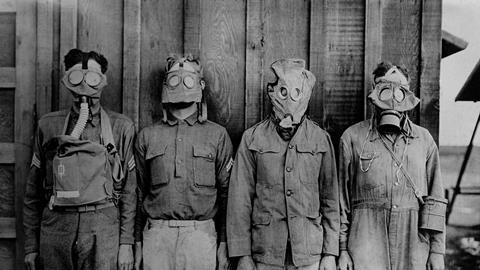 Soldiers wearing WW1 gas masks. L-R: American, British. French, German. 1917-18.