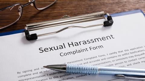 Close-up Of Sexual Harassment Complaint Form With Pen At Desk