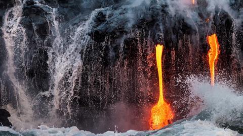 Molten lava flowing into the ocean