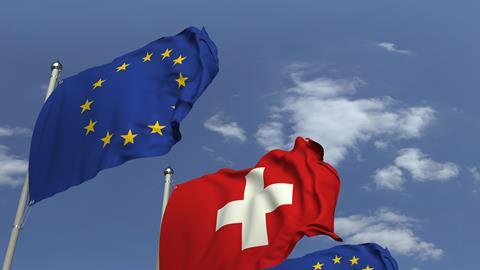 EU and Swiss flags in the wind