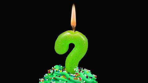 An image showing a birthday candle shaped as a question mark