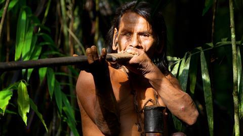 Huaorani hunter using a traditional blowpipe