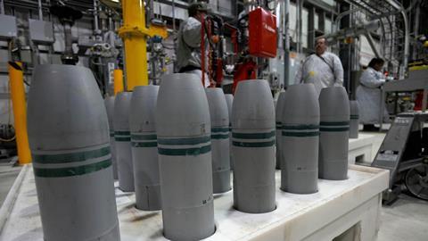 A palette of grey missiles in an industrial unit
