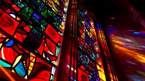 Lights shining through stained glass window 