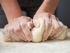 Someone kneading dough