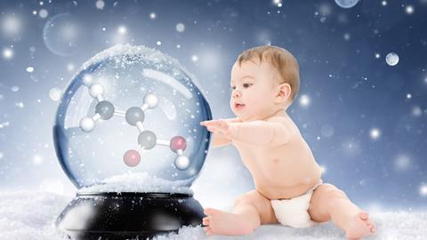 A baby in a disposable nappy with a snowglobe