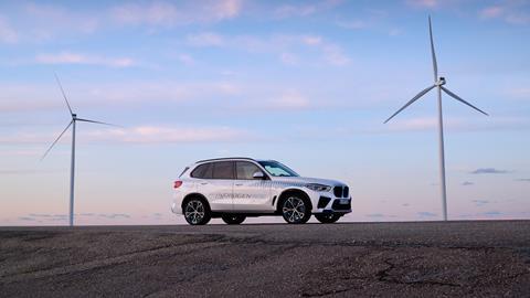 Car next to windmills