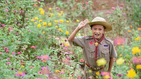 Cub scout surrounded by flowers