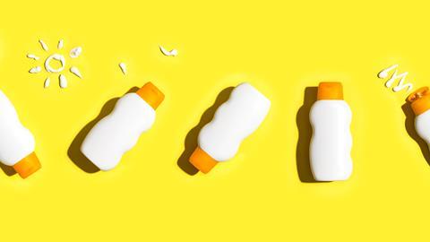 Sunscreen bottles on a yellow background