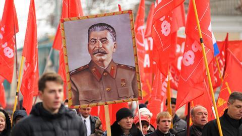A man carries a portrait of Joseph Stalin at a Communist party meeting in Orel, Russia, November 7, 2015