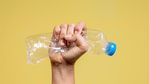 An image showing a hand squeezing a bottle