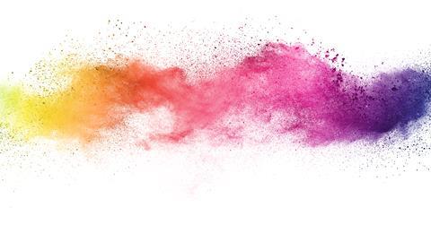 A splash of colourful powder pigments on a white background