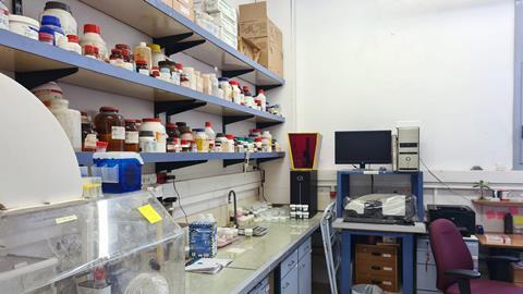 A chemistry lab with chemical bottles on shelves