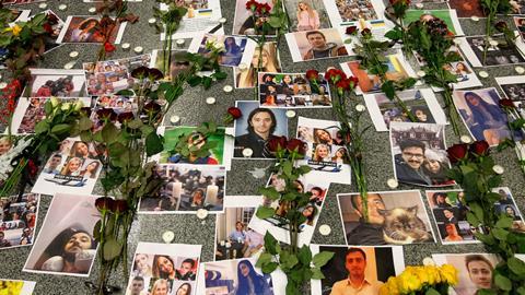 An image showing flowers seen placed on the portraits of the victims of flight PS 752 at the memorial corner of Boryspil International Airport