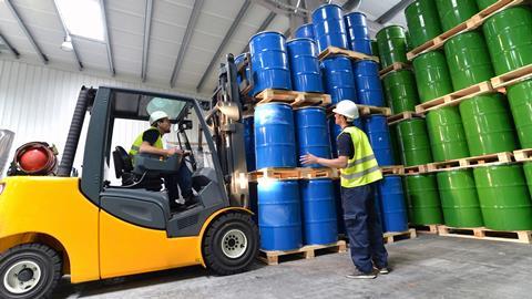 A picture showing a group of workers with forklift 