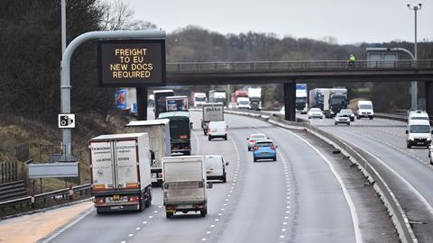 An image showing a motorway and a sign reading 'Freight to Eu new documents required' 