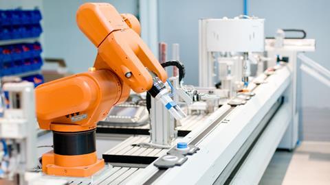 A modern robotic arm works on an assembly line