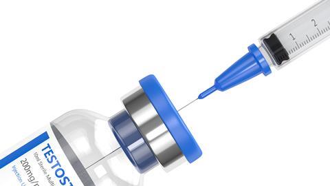 A bottle of Testosterone and a syringe against a white background