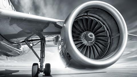 Black and white image showing a jey engine and plane wing